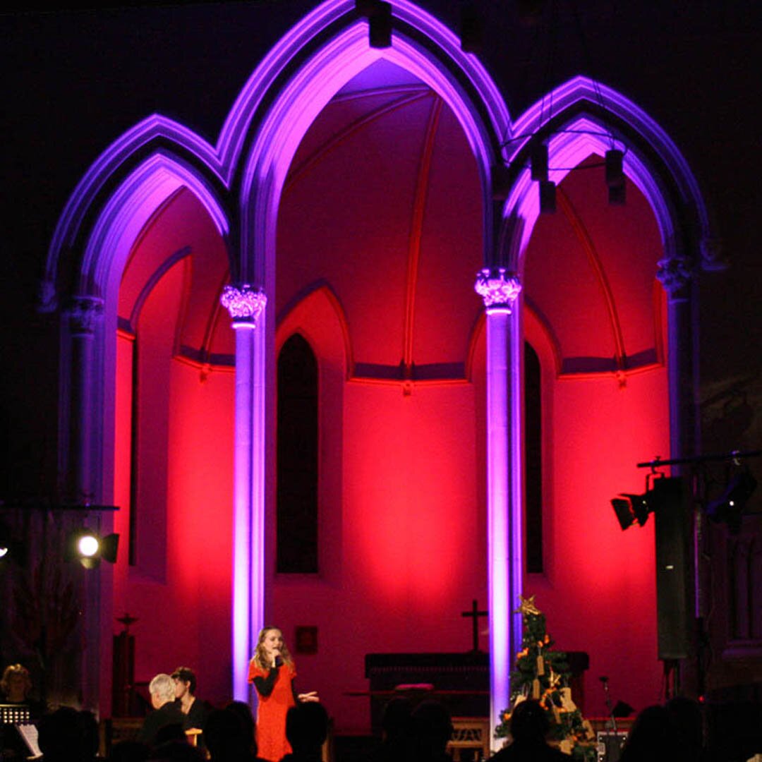 Two LED displays showing the same content in a conference room