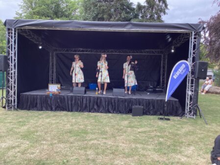 Mobile outdoor stage cover set up at a community event