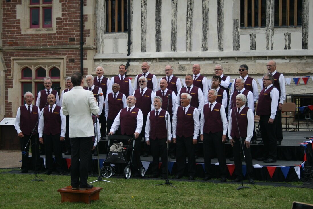 Two LED displays showing the same content in a conference room