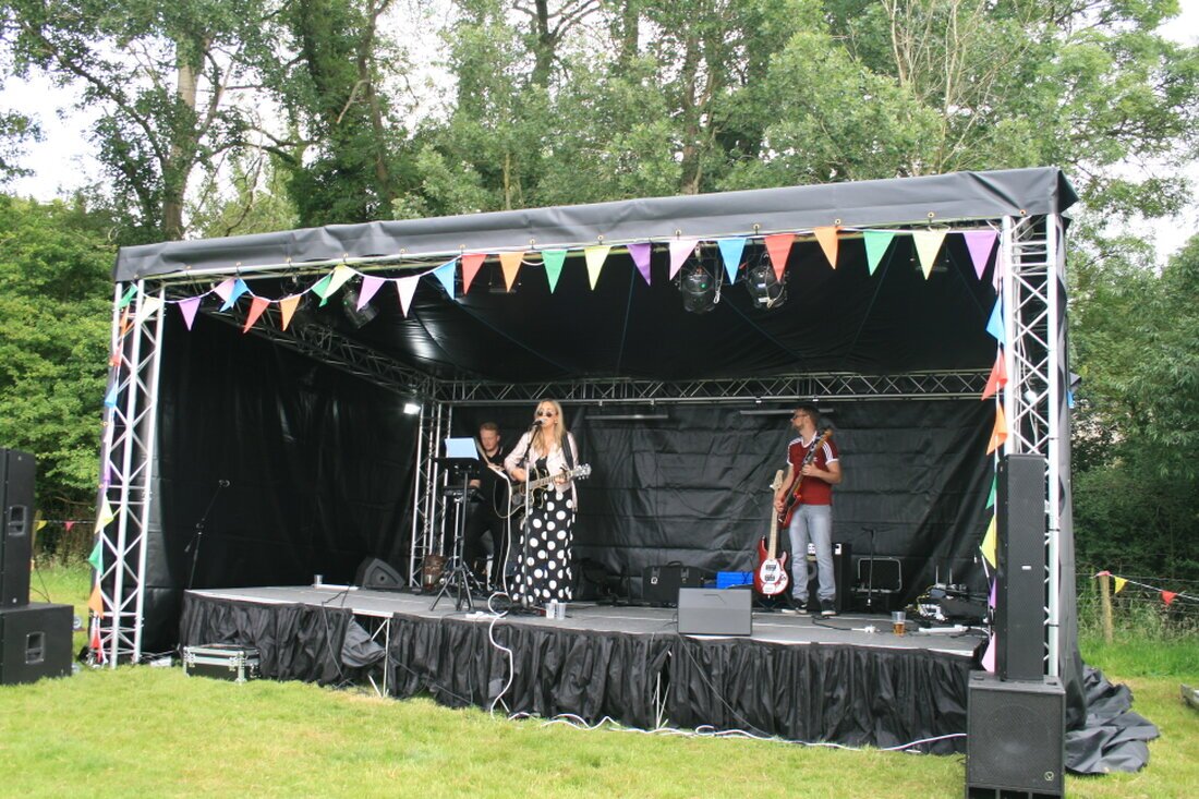 Outdoor speakers on stands at an event