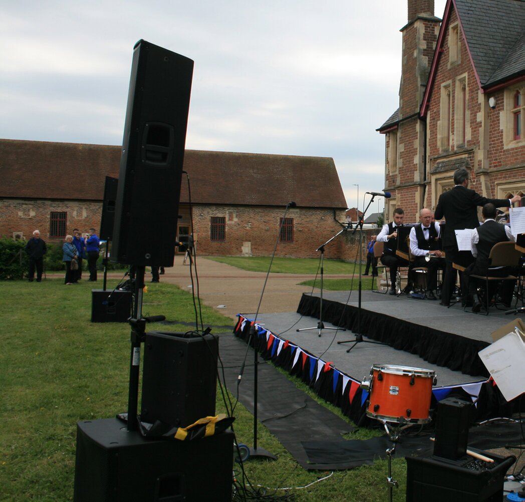 Mixing console and PA speakers at a live event