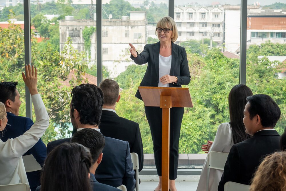 Operator switching multiple cameras for a hybrid conference